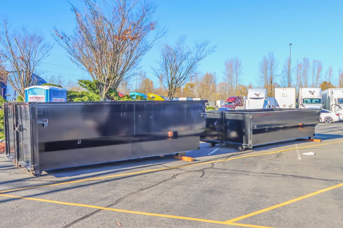 Professional dumpster rental service with roll-off container on residential driveway in Oak View